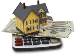 House on a calculator with cash